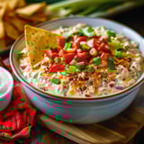 A bowl of food with a tortilla chip on top.