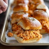 A tray of sandwiches with meat and cheese.