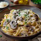 A bowl of pasta with mushrooms and cheese.
