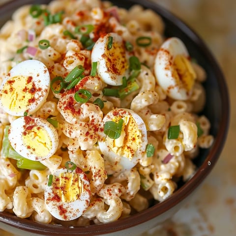 A bowl of macaroni and cheese with eggs.