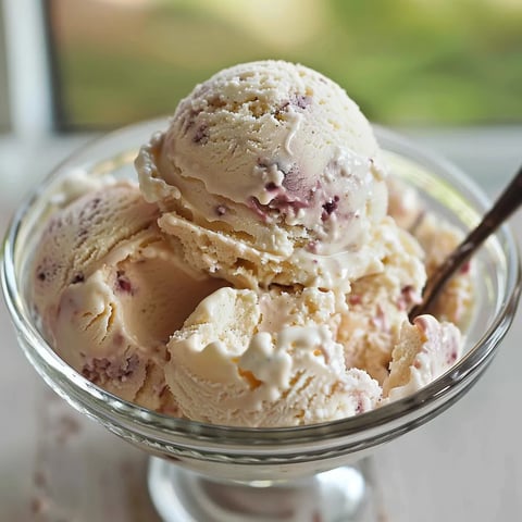 A bowl of ice cream with a spoon in it.